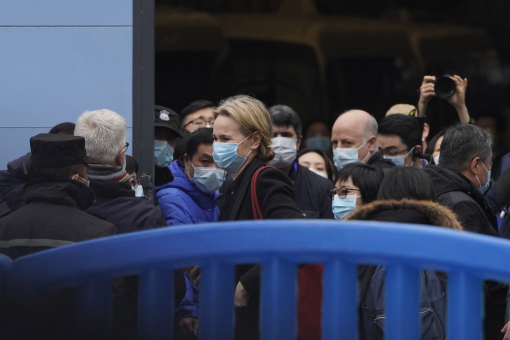 The World Health Organization team is briefed outside the Huanan seafood market on their field visit in Wuhan on January 31. Photo: AP