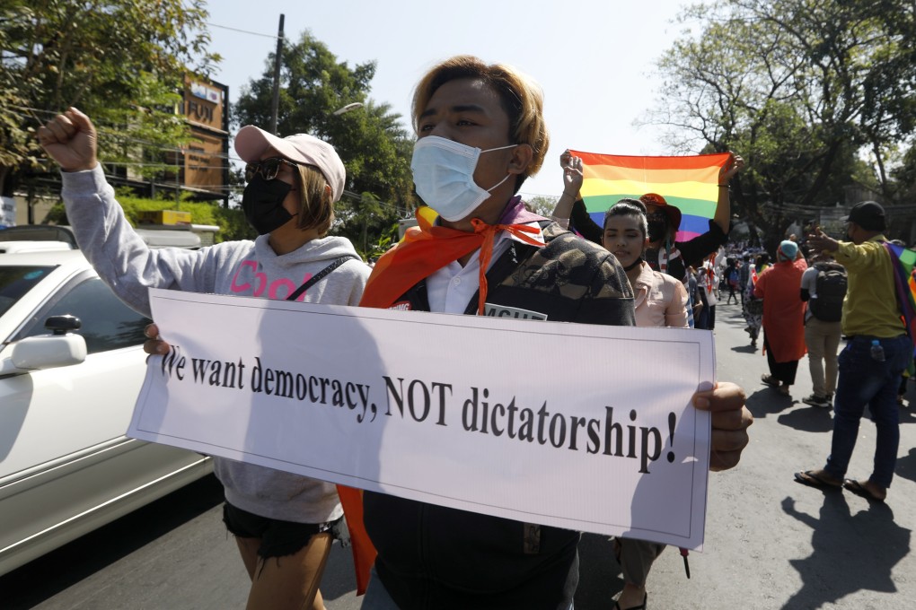 Protesters hold placards and shout slogans as they march in front of the US embassy during a demonstration against the military coup, in Yangon, Myanmar, on February 10. People have continued to rally across the country despite orders banning mass gatherings and reports of increasing use of force by police against anti-coup protesters. Photo: EPA-EFE