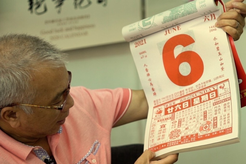 Leung Yu-time, a publisher in Hong Kong, holds up one of his company’s calendars. Photo: Goldthread