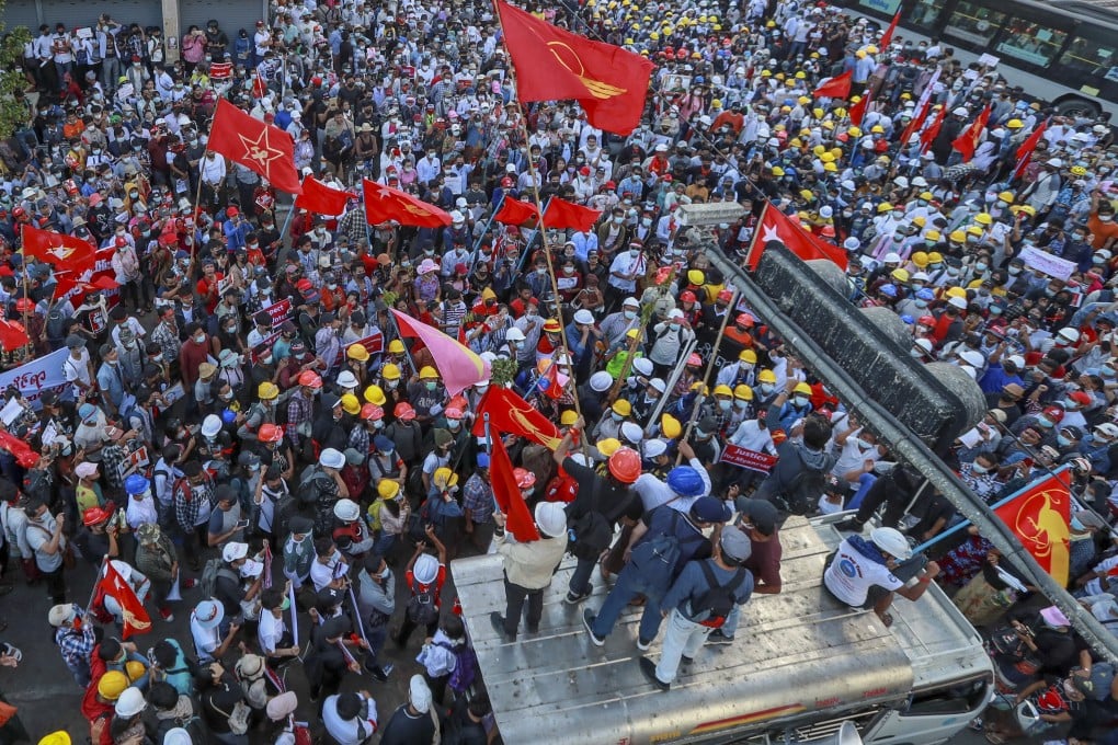 Demonstrators wave flags of the National League for Democracy party during a protest against the military coup in Yangon, Myanmar, on Wednesday. Photo: AP