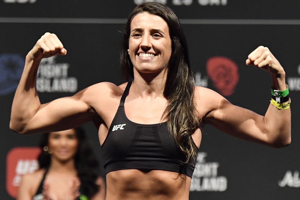 Marina Rodriguez poses on the scale during the UFC 257 weigh-in at Etihad Arena on UFC Fight Island. Photo: Jeff Bottari/Zuffa LLC
