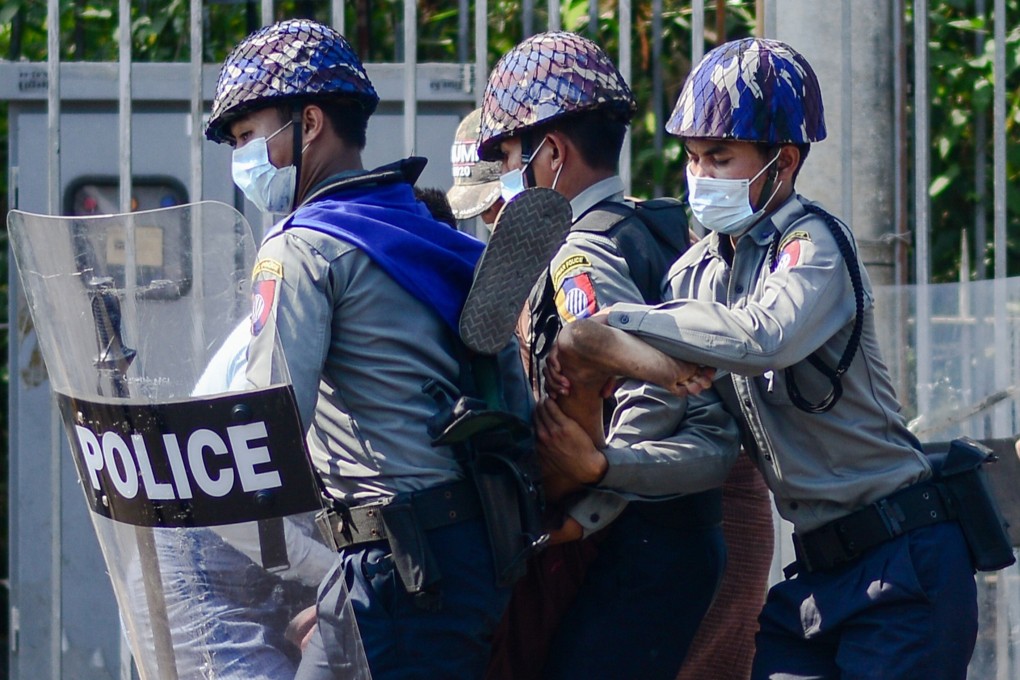Police arrest a protester during a demonstration against the military coup in Mawlamyine on February 12, 2021. Photo: STR/AFP
