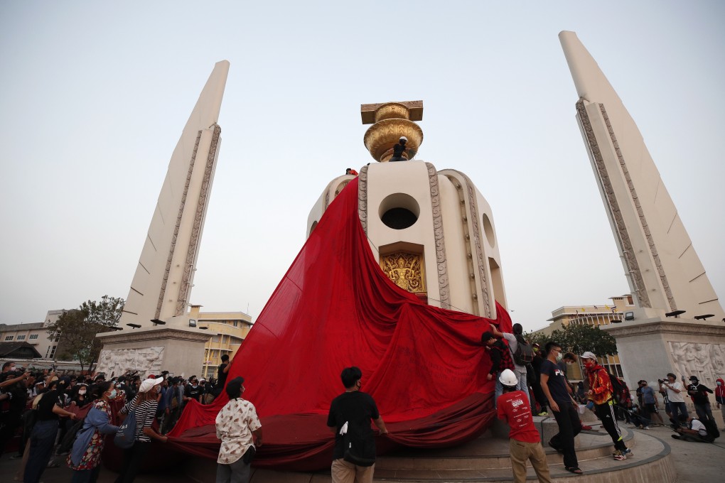 Anti-government protesters cover the Democracy Monument with a crimson cloth during a rally in Bangkok on Saturday. Photo: EPA-EFE