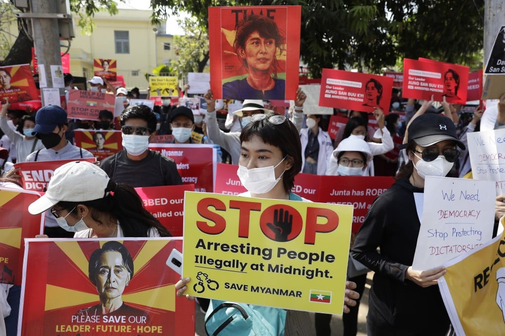 Demonstrators hold placards calling for the release of Aung San Suu Kyi and the end of nightly arrest raids, during a protest against the military coup in Yangon on February 14. Photo: EPA-EFE