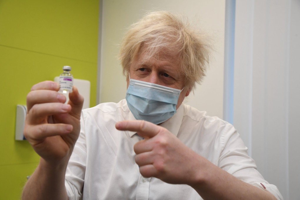 Britain’s Prime Minister Boris Johnson poses with a vial of AstraZeneca’s Covid-19 vaccine during a visit to a health centre in London on Monday. Photo: AFP