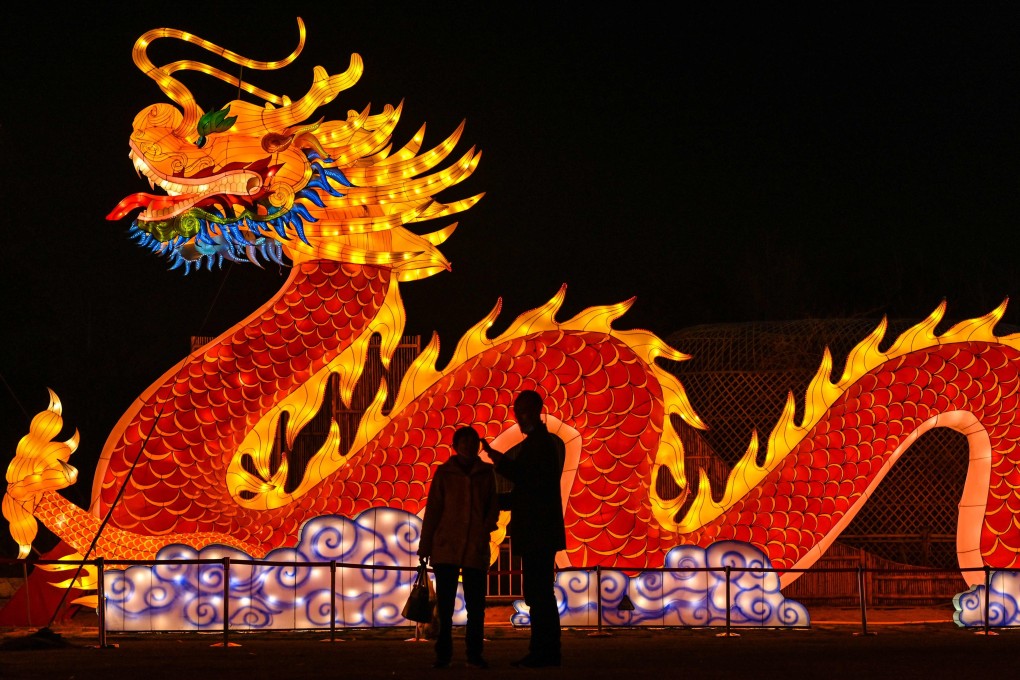 People talk in front of a giant dragon lantern in a park in Wuhan in China’s central Hubei province on Thursday. Photo: AFP