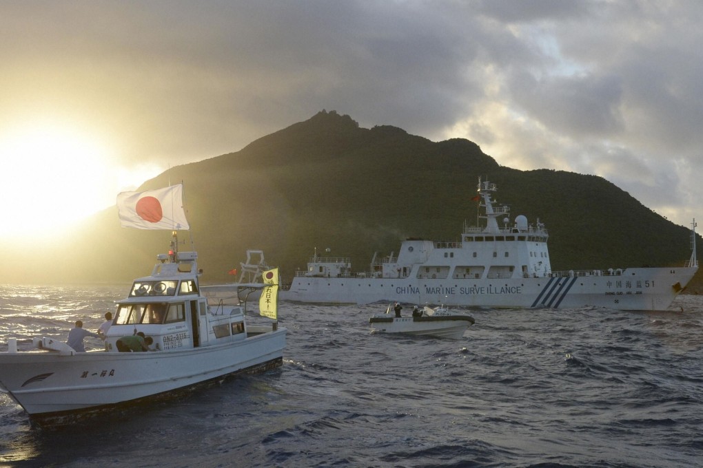 A Chinese marine surveillance ship sails near Japan Coast Guard vessels (out of shot) and a Japanese fishing boat near one of the disputed Diaoyu Islands on July 1, 2013. Photo: Kyodo/Reuters