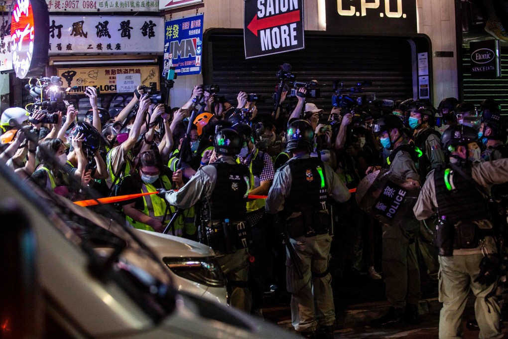 Hong Kong police hold back members of the press during an operation to arrest pro-democracy demonstrators in Mong Kok on May 10, 2020. Photo: AFP