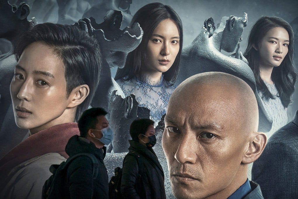 People wearing face masks walk past a hoarding for a movie in a subway station in Beijing. Photo: AP Photo