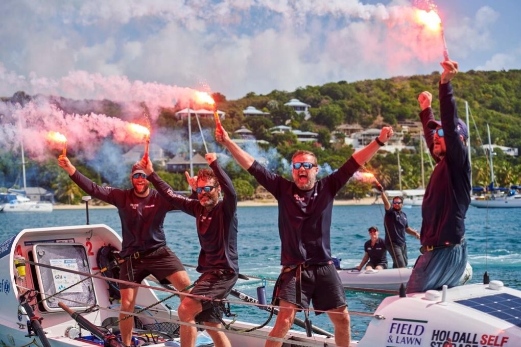 Josh Stone (left) and his “Fitter Planet” teammates celebrate on arriving in Antigua. Photo: Ben Duffy
