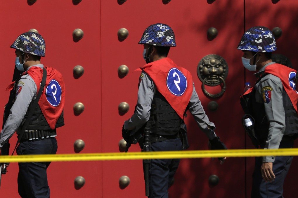 Police officers guard an entrance to the Chinese embassy during a protest against the military coup in Yangon, Myanmar on Sunday. Photo: EPA-EFE
