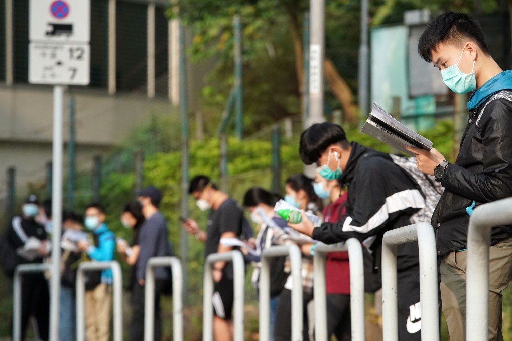 Last-minute revisions as students wait to be seated for the Diploma of Secondary Education exam at a school in Tsuen Wan in April 2020. Photo: Felix Wong