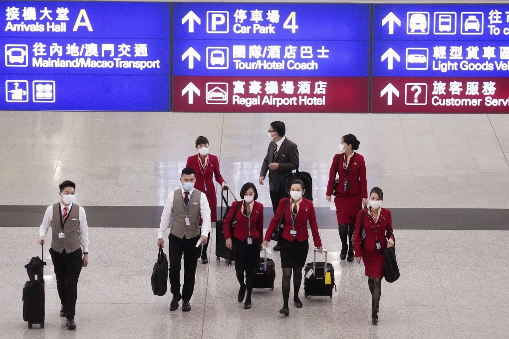 Cathay Pacific staff walk through a largely deserted Hong Kong International Airport. Photo: Winson Wong