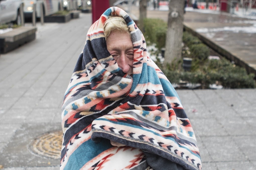 A woman bundles up in a blanket outside a warming shelter in Houston, Texas. Photo: AP