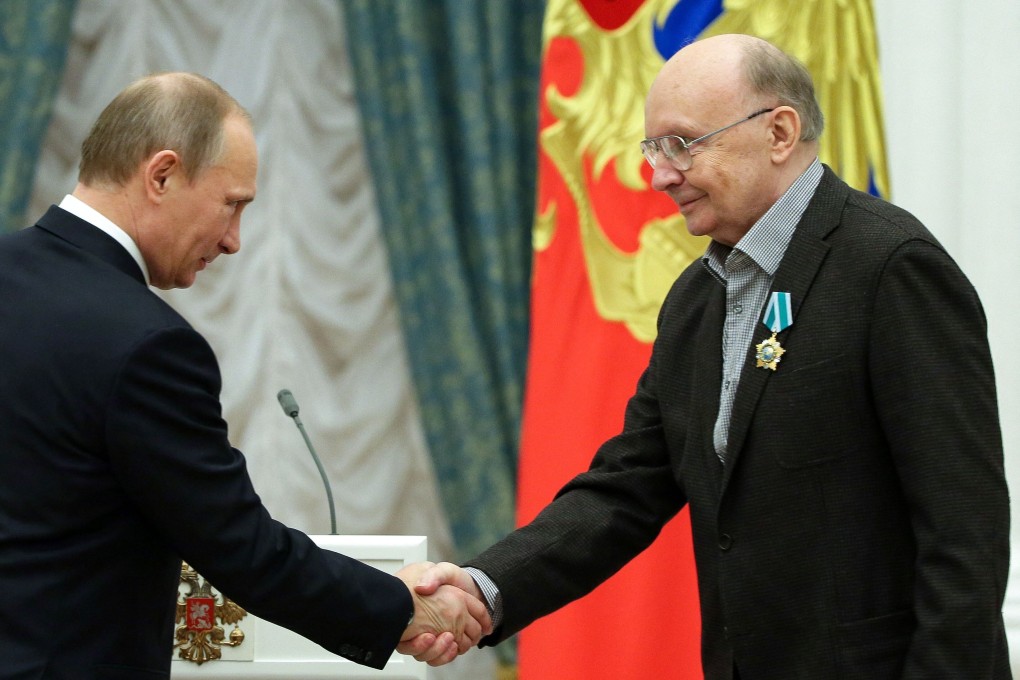 Russian President Vladimir Putin (left) shakes hands with actor Andrei Myagkov during an awards ceremony in Moscow in 2013. Photo: AFP