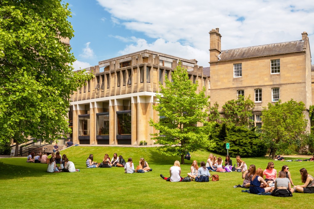 Students sit on the lawn outside Balliol College at Oxford University. Photo: Shutterstock