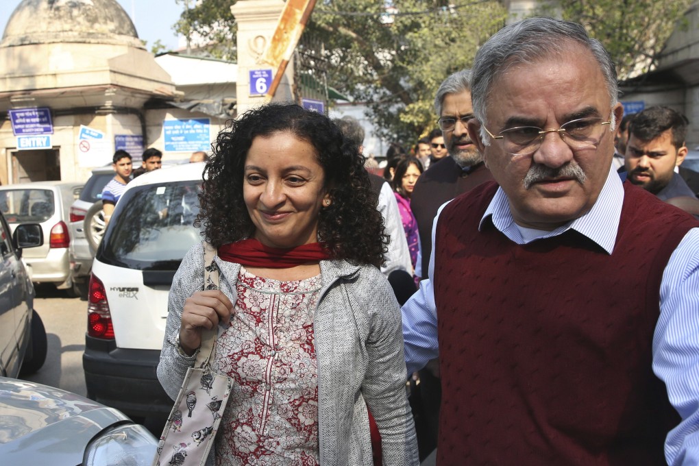 Indian journalist Priya Ramani, left, smiles after the Patiala House Court in New Delhi acquitted her of criminal defamation after she accused a former politician of sexual harassment. Photo: AP