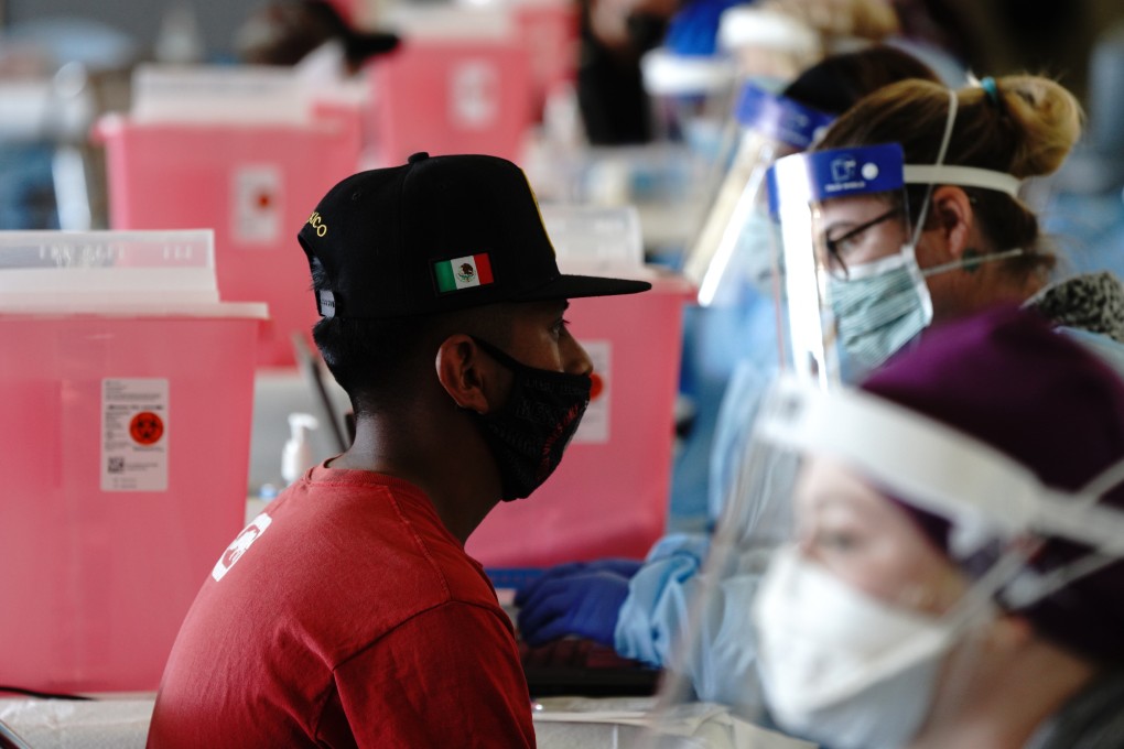 A farmworker waits to receive a dose of the Pfizer Covid-19 vaccine at a clinic in Coachella, California. Photo: Bloomberg