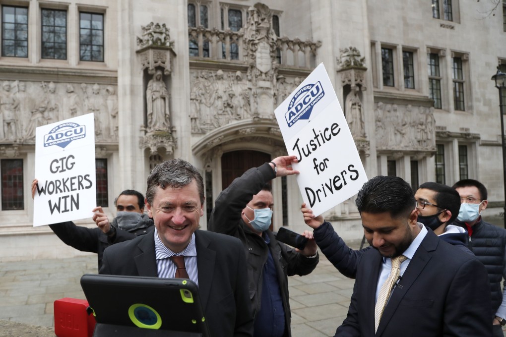 Uber drivers celebrate outside the Supreme Court in London on Friday. Photo: AP