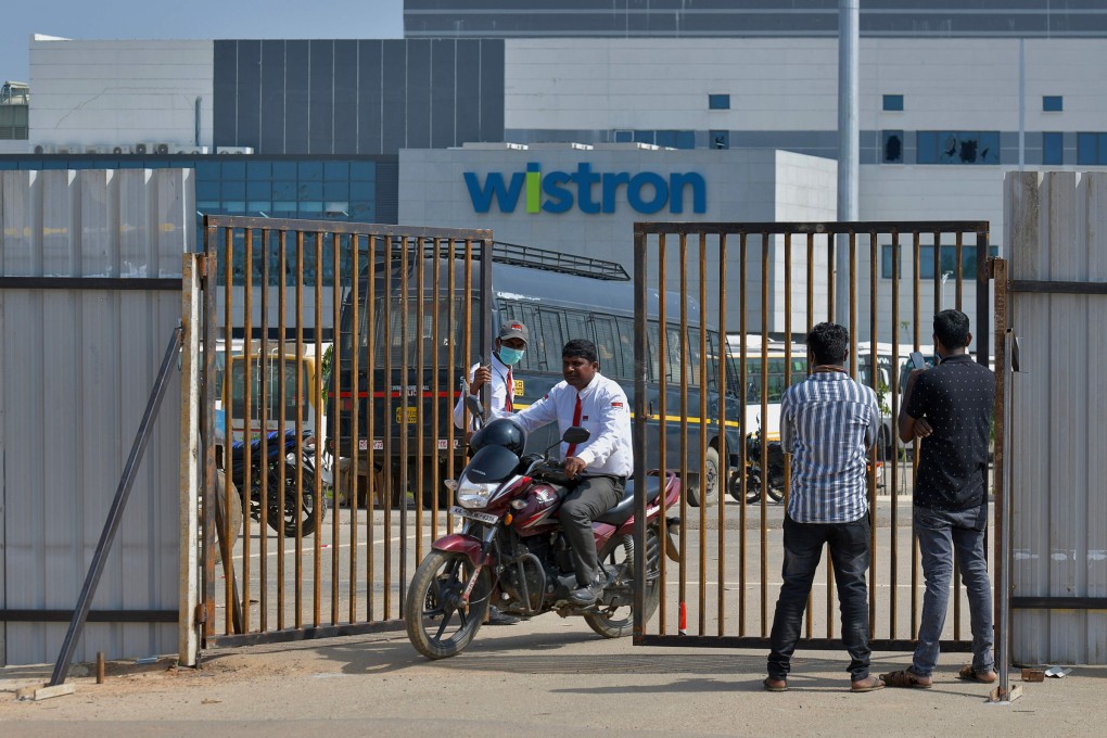 People exit from the gate of Wistron, a Taiwanese-run iPhone factory at Narsapura, about 60 km from Bangalore on December 13, 2020. Photo: AFP