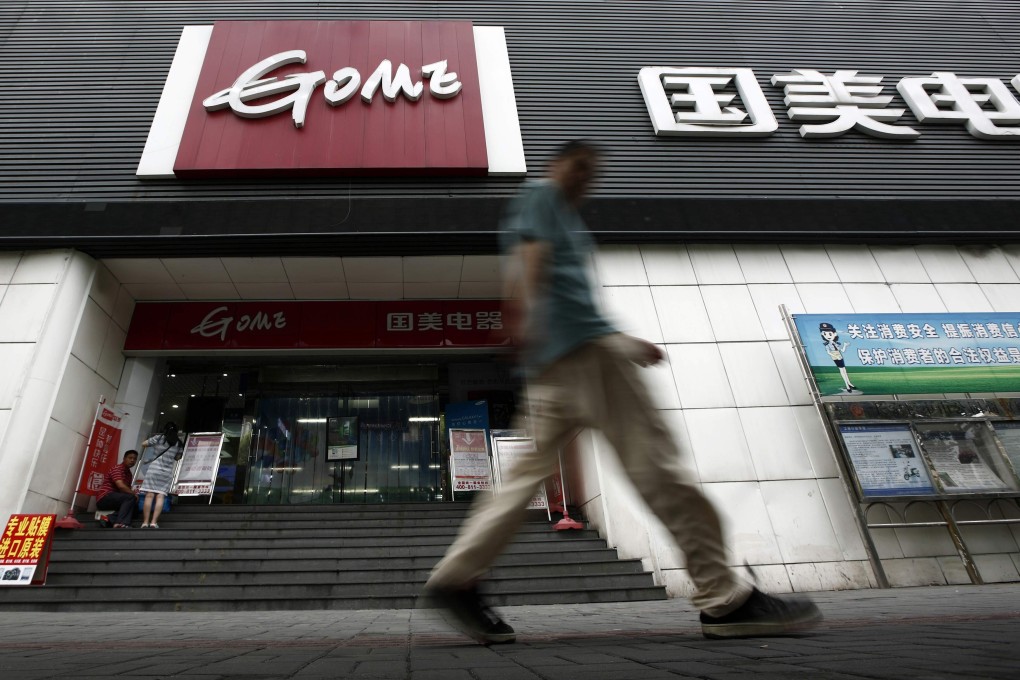 A man walks past a Gome store in Shanghai, China on August 26, 2013. Photo: Reuters