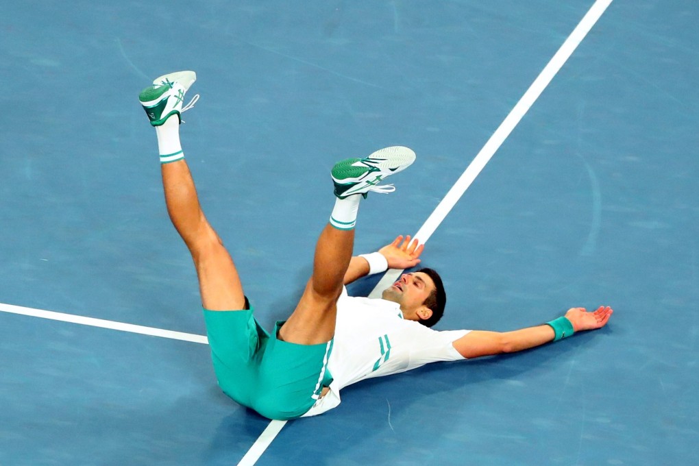 Novak Djokovic celebrates on the ground after winning his ninth Australian Open title by beating Daniil Medvedev in the final. Photo: Reuters