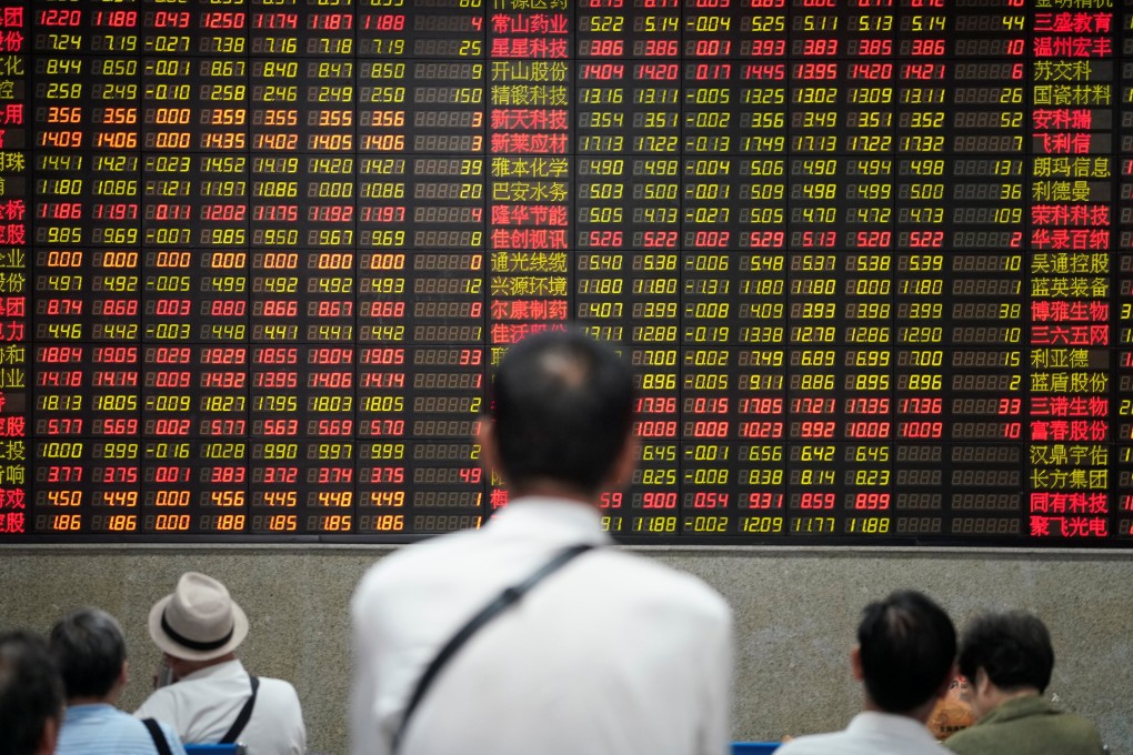 Retail investors look at an electronic board showing stock information at a brokerage house in Shanghai. Photo: Reuters