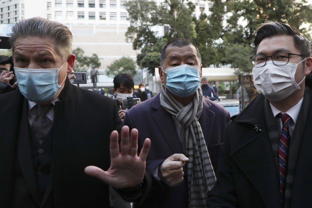 A High Court judge has cited Apple Daily founder Jimmy Lai’s (centre) risk of reoffending in her reasoning for denying him bail. Photo: Sam Tsang