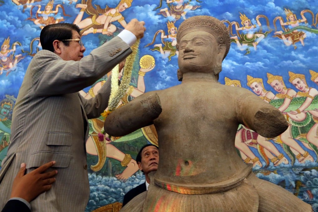 A 10th-century statue is presented at a 2014 ceremony in Phnom Penh, one of three works welcomed home four decades after they were looted from the country in the 1970s. Photo: AFP