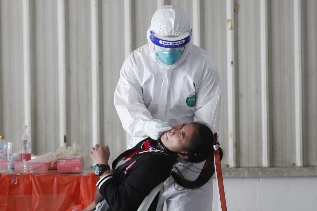 A health worker takes a nasal swab sample from a woman worker in Nonthaburi province, Thailand. Photo: EPA-EFE