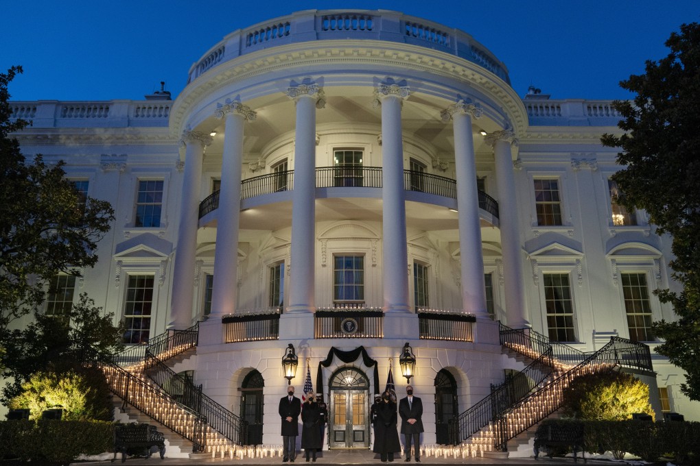 US President Joe Biden, first lady Jill Biden, Vice-President Kamala Harris and her husband Doug Emhoff hold a moment of silence in memory of US Covid-19 victims at the White House on Monday. Photo: AP