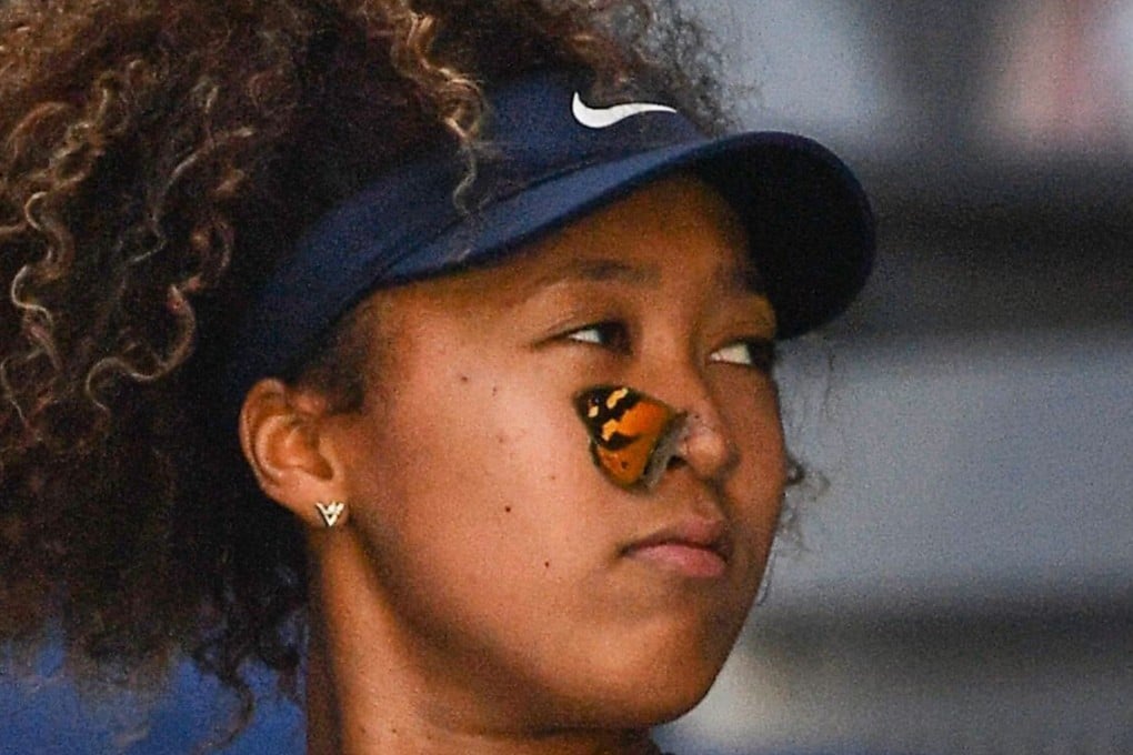 A butterfly lands on Naomi Osaka’s face before she gently carries it to safety during her march to the Australian Open title. Photo: AFP