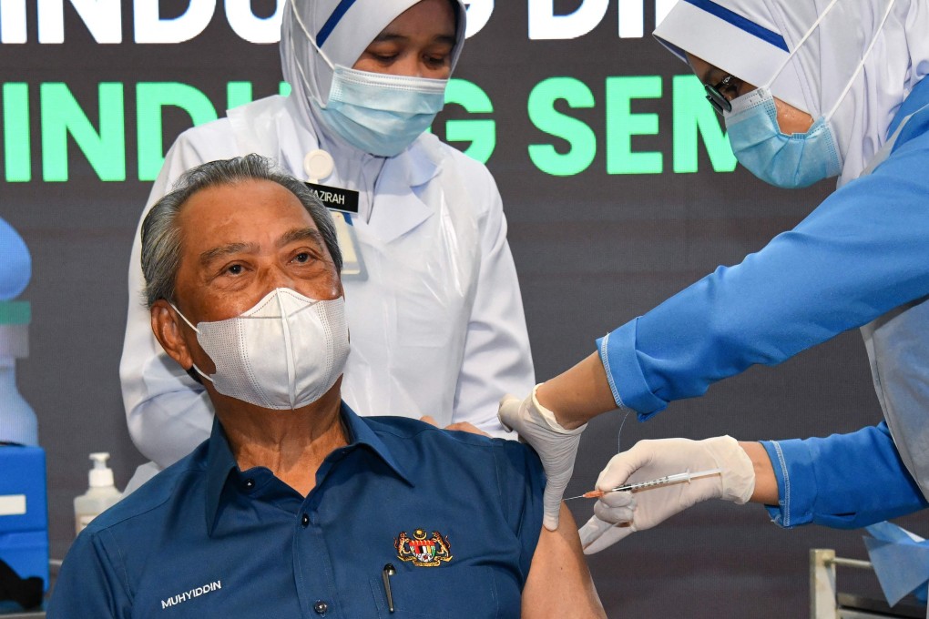 Malaysia's Prime Minister Muhyiddin Yassin receiving the first dose of the Pfizer/BioNTech Covid-19 vaccine at a government clinic in Putrajaya on Wednesday. Photo: AFP
