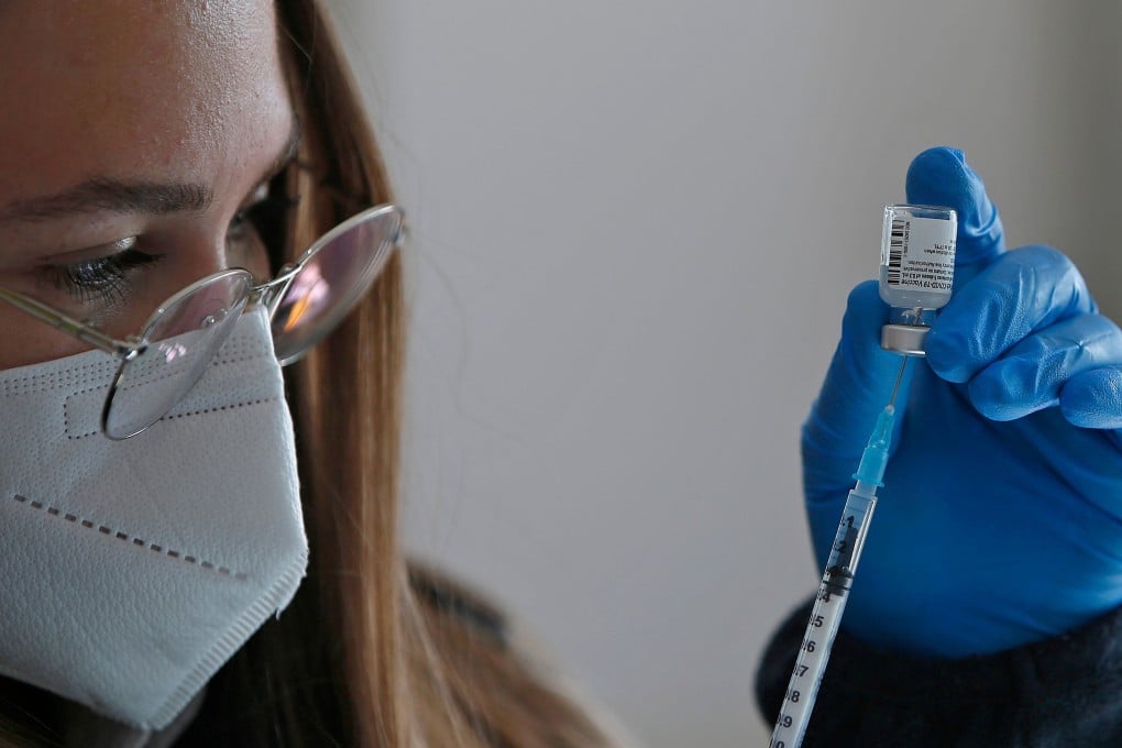 A health worker prepares a dose of the Pfizer-BioNtech Covid-19 coronavirus vaccine at a mobile clinic in Israel. Photo: AFP