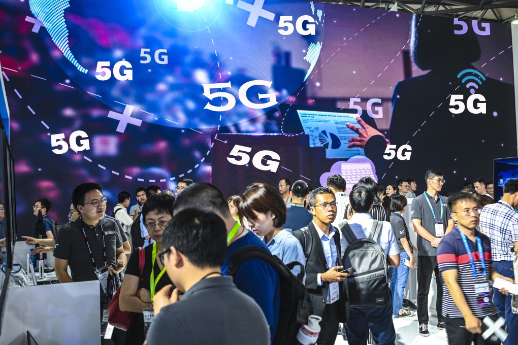 Visitors pass in front of a 5G advertisement during the MWC Shanghai trade show, held at Shanghai New International Expo Centre on June 27, 2019. Photo: Getty Images