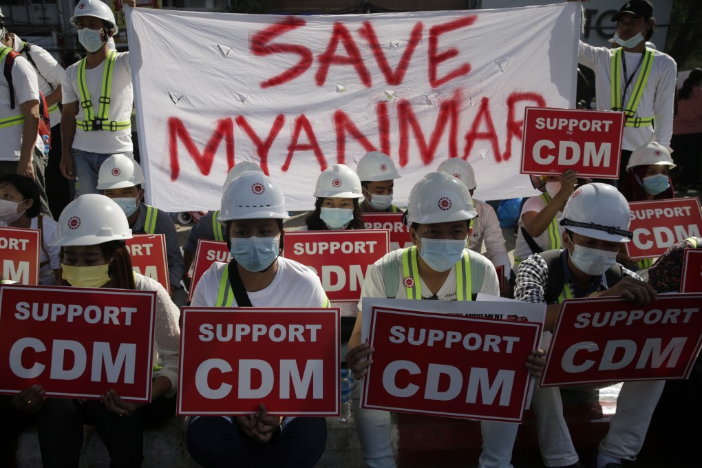 Demonstrators hold placards showing support for the civil disobedience movement (CDM) during a protest against the military coup in Yangon on Thursday. Photo: EPA-EFE
