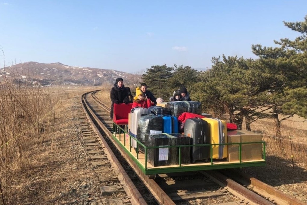 A group of Russian diplomats, including their children, pushed themselves for over 1km over train tracks to leave North Korea. Photo: Russian Foreign Ministry/Facebook