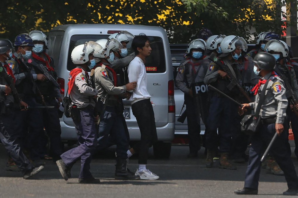 Police arrest a protester during a demonstration against the military coup in Yangon on Friday. Photo: AFP