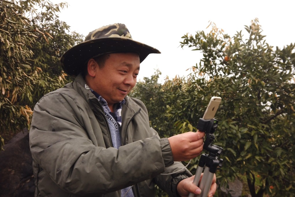 Zhong Haihui, a fruit farmer from central China's Hunan province, sells his produce by live-streaming from an iPhone. Zhong is one of many rural residents benefiting from a push by e-commerce giants to boost sales in impoverished regions. Photo: Chris Chang