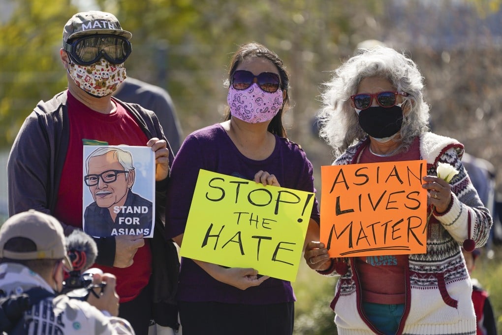 A man holds a portrait of a 84-year-old immigrant from Thailand who was violently shoved to the ground in a deadly attack in San Francisco last month, during a community rally to raise awareness of anti-Asian violence held near the Chinatown district in Los Angeles on February 20. Photo: AP