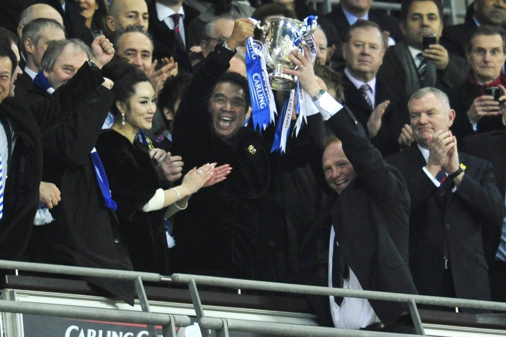 Birmingham City's coach Alex McLeish (right) and Hong Kong owner of the club, Carson Yeung Ka-sing, hold the trophy at the end of the 2011 Carling Cup final. The team beat Arsenal 2-1. Photo: AFP