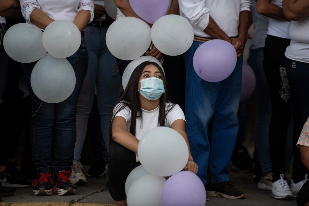 Protesters at a religious event in memories of three young women murdered in the town of Turen in the state of Portuguesa, Venezuela. Photo: AFP
