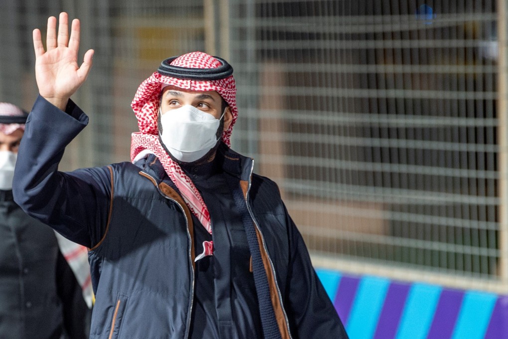 Saudi Crown Prince Mohammed bin Salman waves as he arrives at Diriyah E-Prix 2021 in Riyadh, Saudi Arabia, on Saturday. Photo: Bandar Algaloud / Courtesy of Saudi Royal Court / Reuters