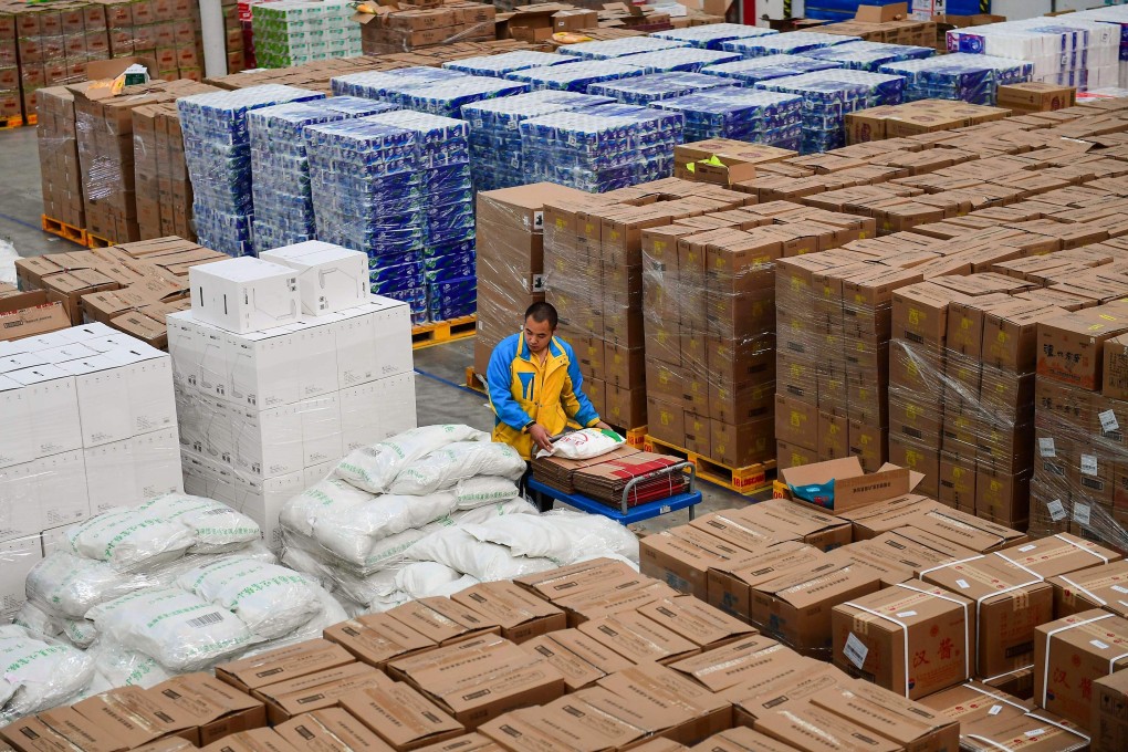 A worker transfers items in preparation for the “Singles‘ Day” shopping festival at a storage facility of Suning in Shenyang in China's northeastern Liaoning province on October 24, 2018. Photo: AFP