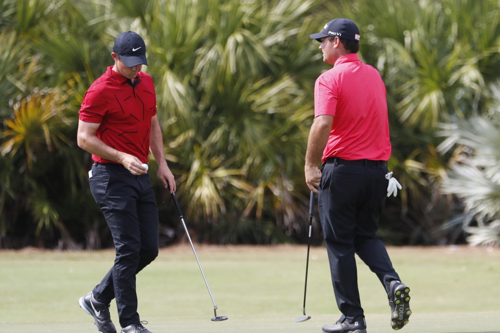 Rory McIlroy of Northern Ireland, left, and Patrick Reed of the US wear a red top and black trousers as a tribute to Tiger Woods on Sunday. Photo: EPA-EFE