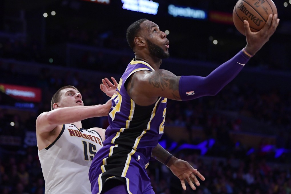 Los Angeles Lakers forward LeBron James, shoots as Denver Nuggets centre Nikola Jokic watches on. The pair will play in the NBA All-Star game. Photo: AP