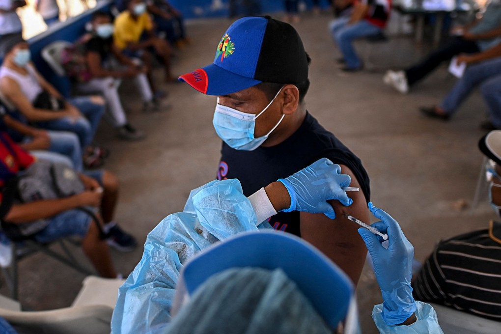 An employee of Panama’s sanitation service is inoculated with the Pfizer-BioNTech vaccine against Covid-19 in Panama City on Friday. Photo: AFP