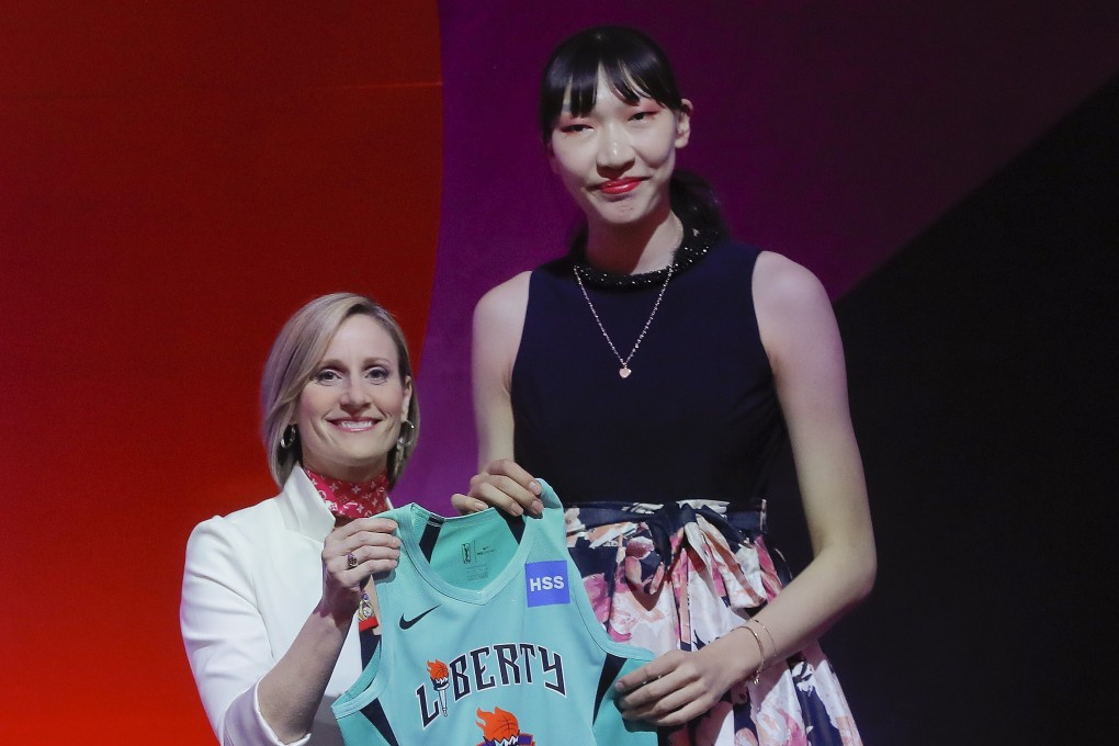Han Xu of China with WNBA COO Christy Hedgpeth after being selected by the New York Liberty in the second round of the women‘s basketball draft in 2019. Photo: AP