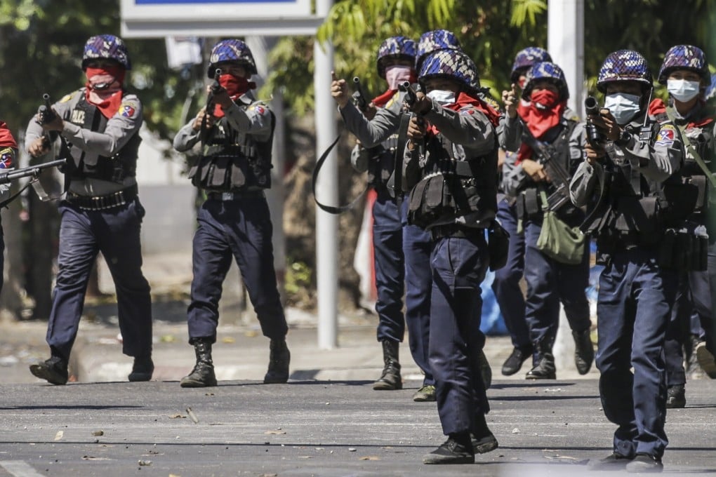 Anti-riot police officers prepare to fire tear gas to disperse protesters during an anti-coup protest. They have been asked to refrain from using live rounds during demonstrations. Photo: EPA-EFE