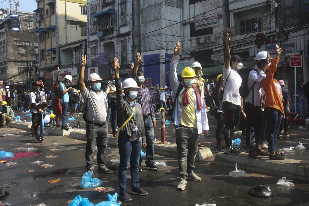 Protesters flash three-finger salutes during an anti-coup demonstration on a blocked road in Yangon, Myanmar. Photo: AP